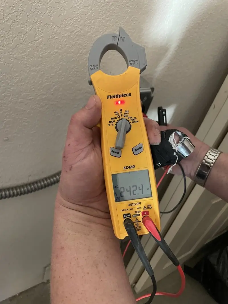 Voltage testing with clamp meter during Outlet Installation in Walden